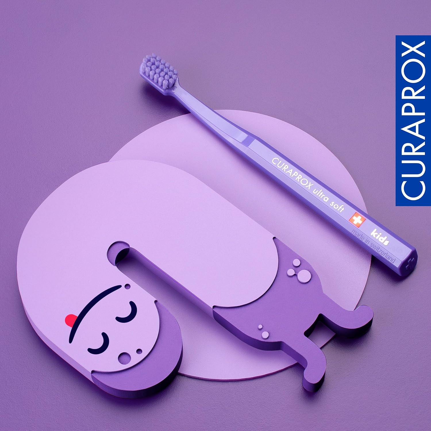 Curaprox Kids purple toothbrush with ergonomic octagonal handle for children aged 4 to 12 to build healthy brushing habits