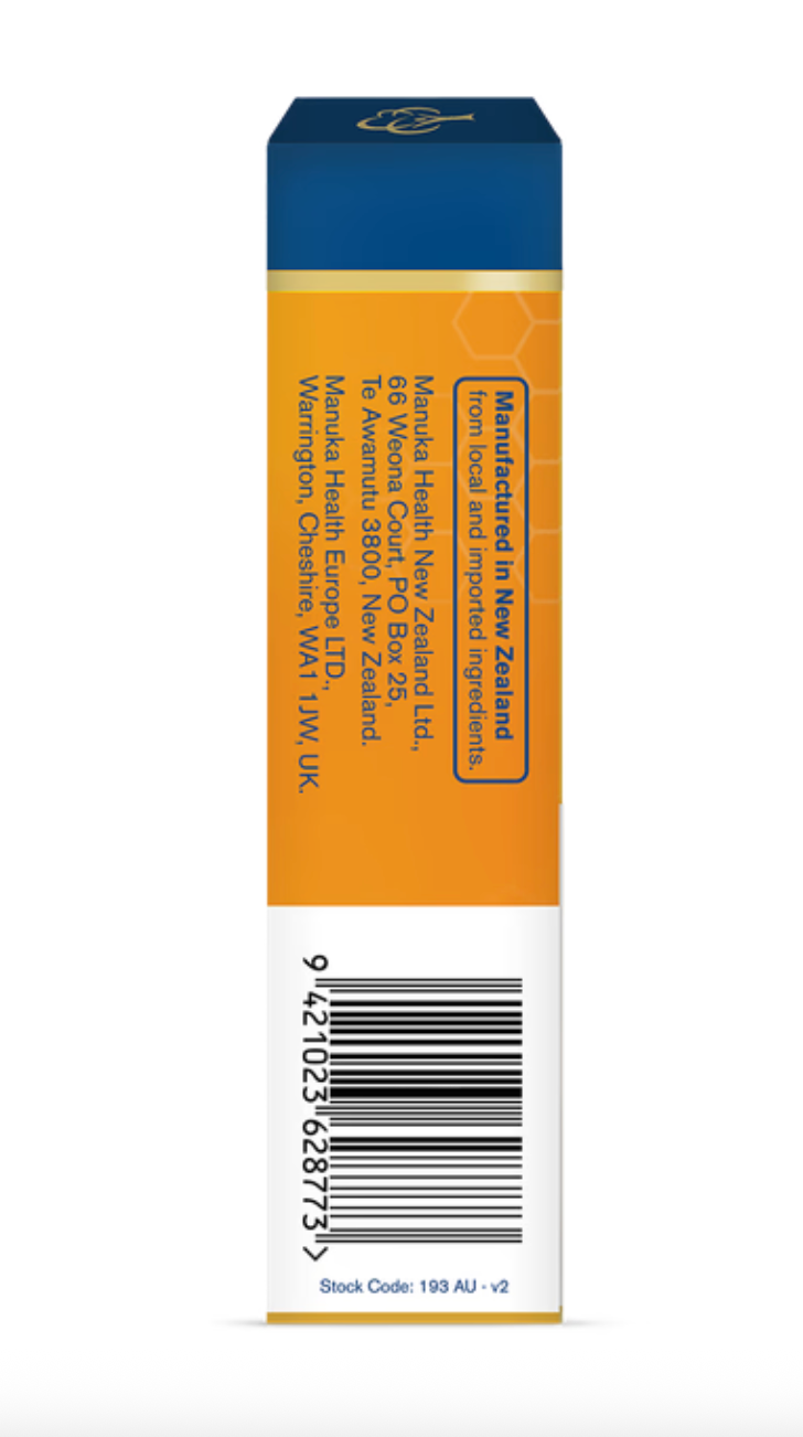 Person dissolving a Manuka Health ginger lemon honey drop to soothe throat naturally