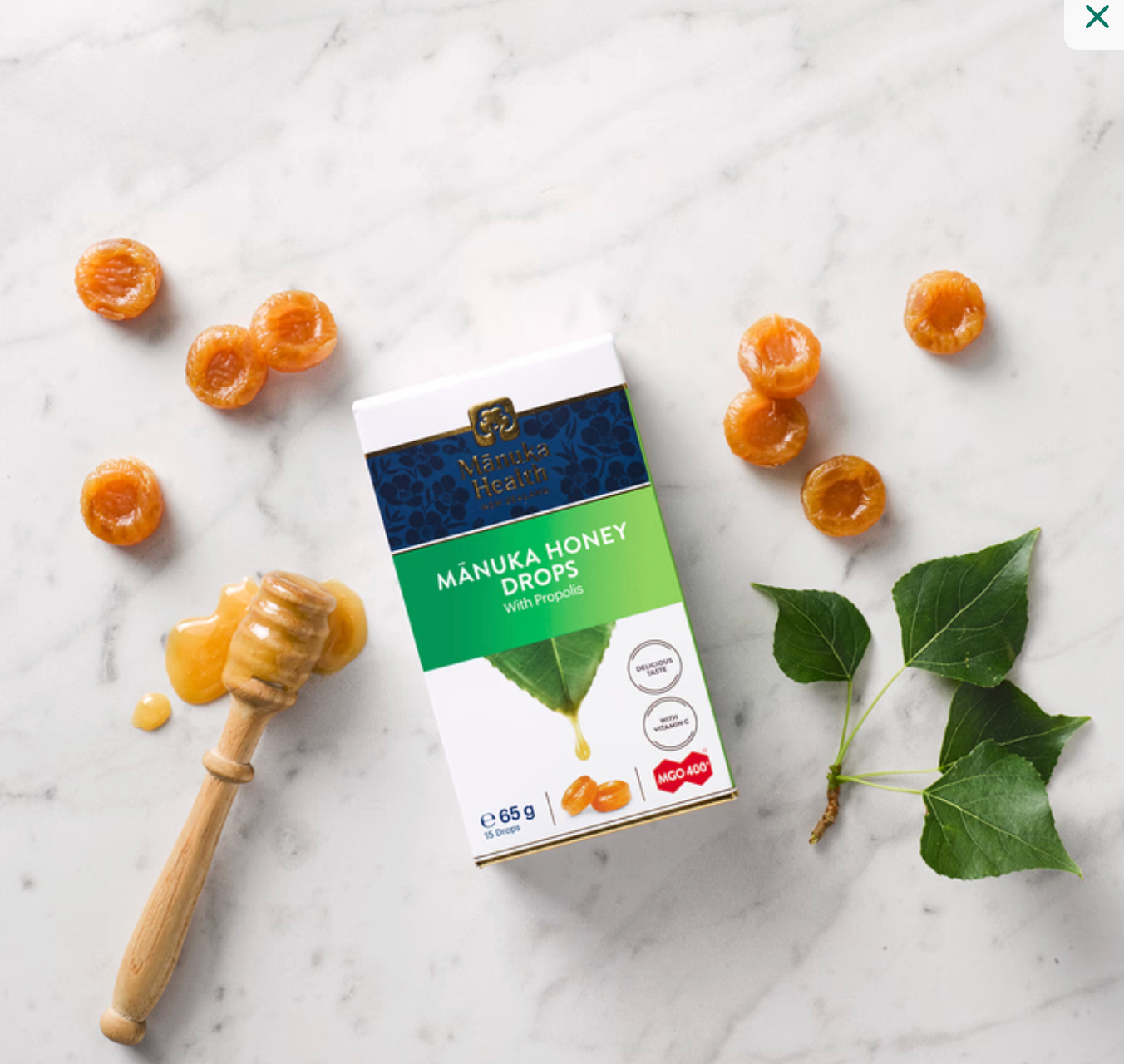 Person dissolving a Manuka Health honey drop with propolis to soothe throat naturally