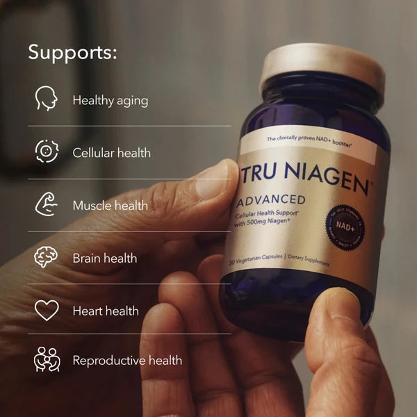 Tru Niagen Advanced 500mg bottle held in hands — supports healthy aging, cellular health, muscle, brain, heart and reproductive health